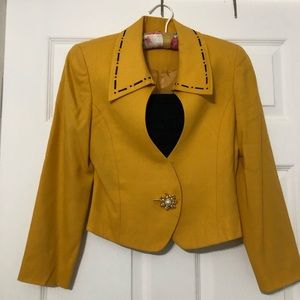 yellow jacket on the collar with black designs.